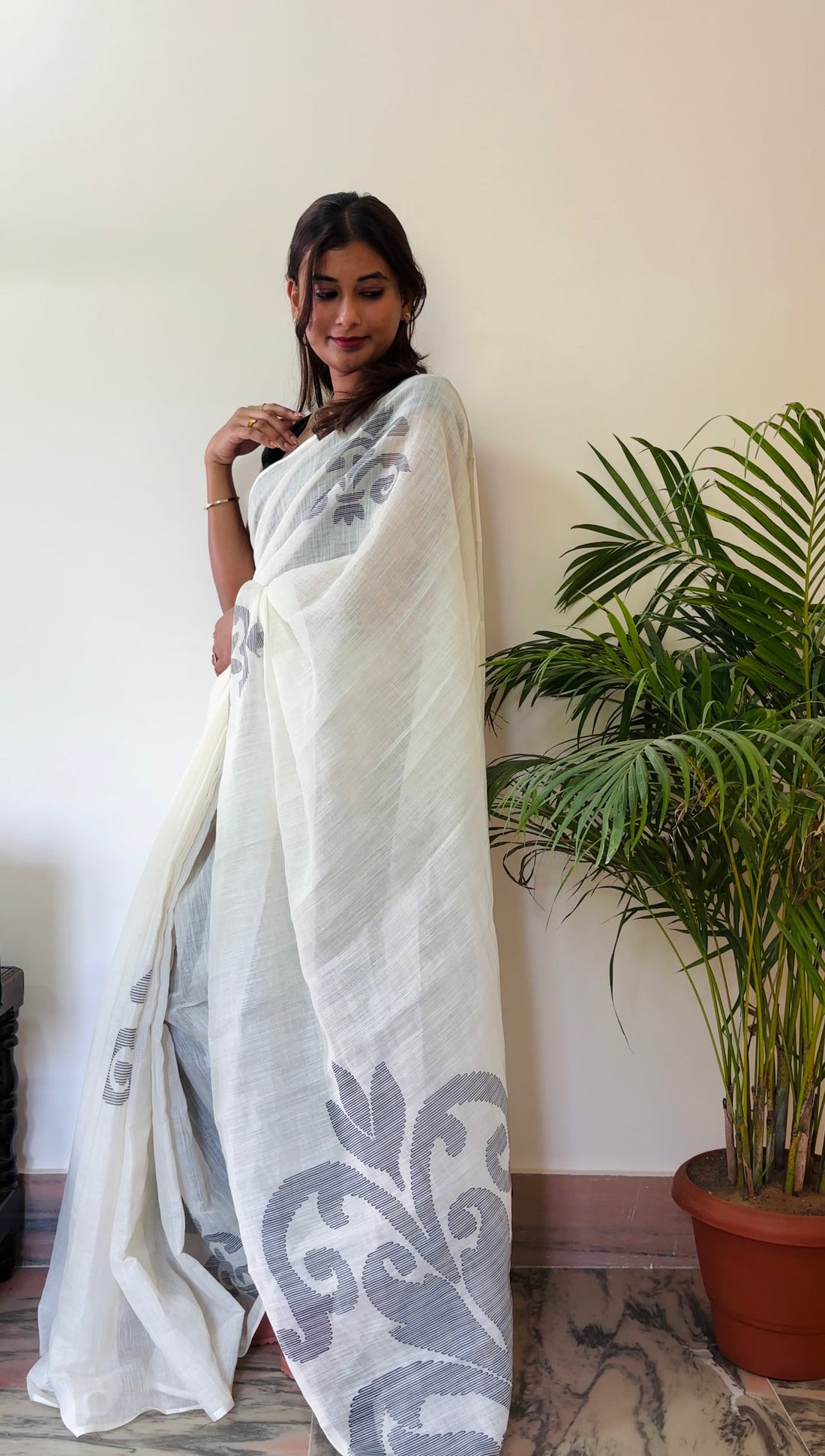 Woman wearing a stylish ready-to-wear saree with modern design and perfect pleats