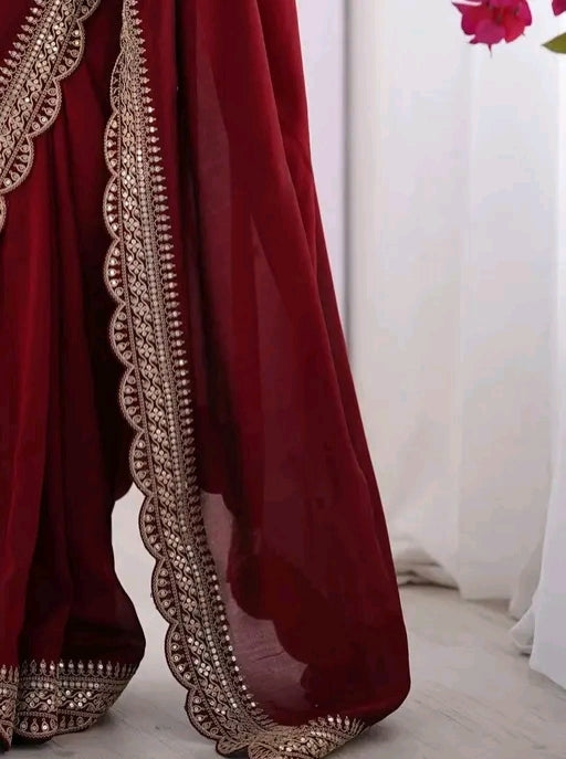 Red party wear saree with sleeveless blouse